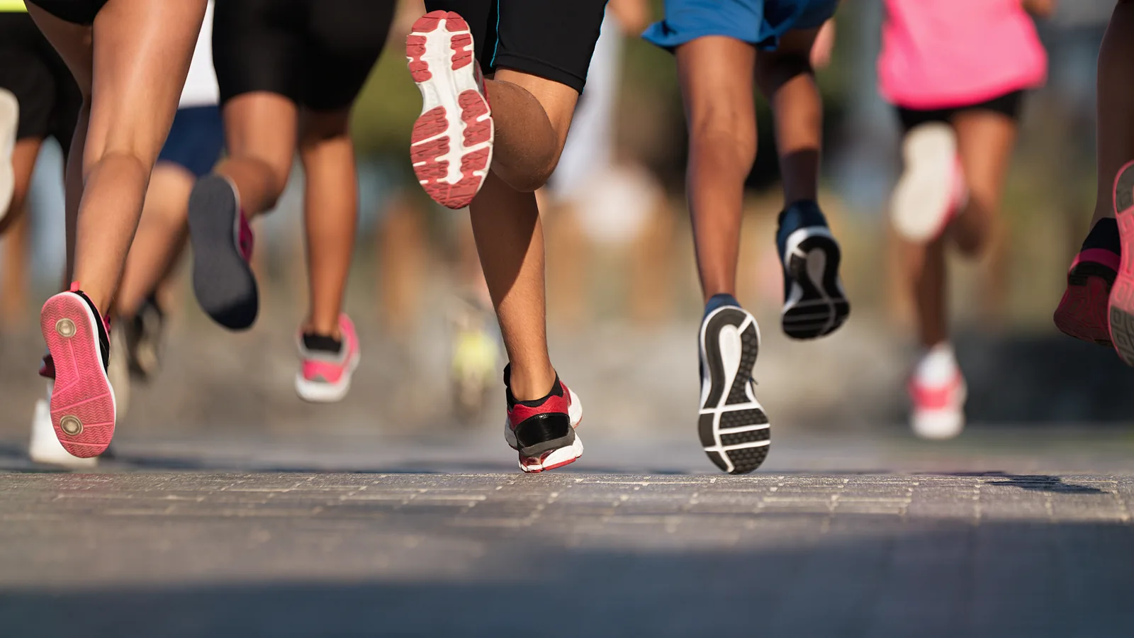 Close-up of a group of people running along a path
